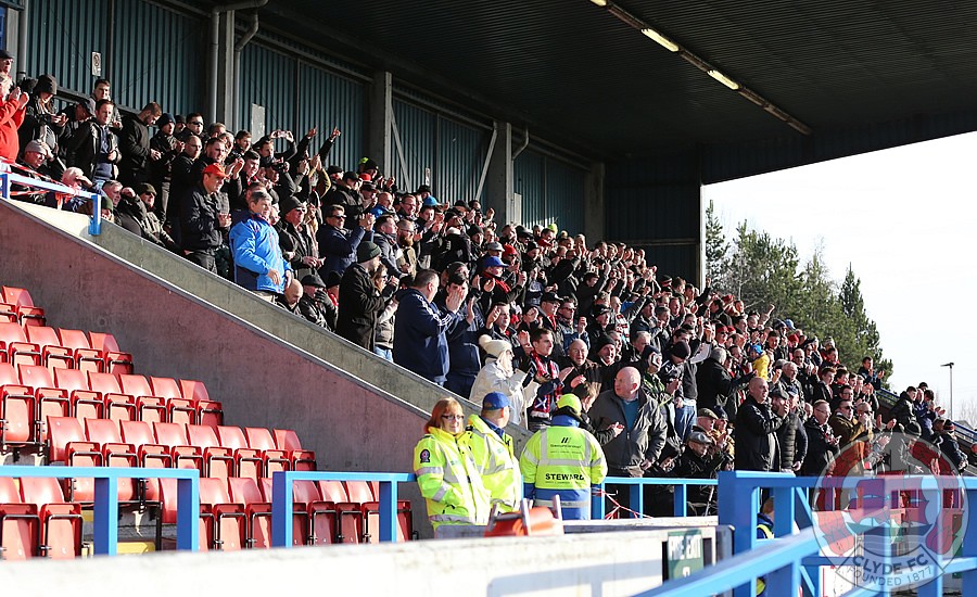 The away support on its feet after Clyde's goal.