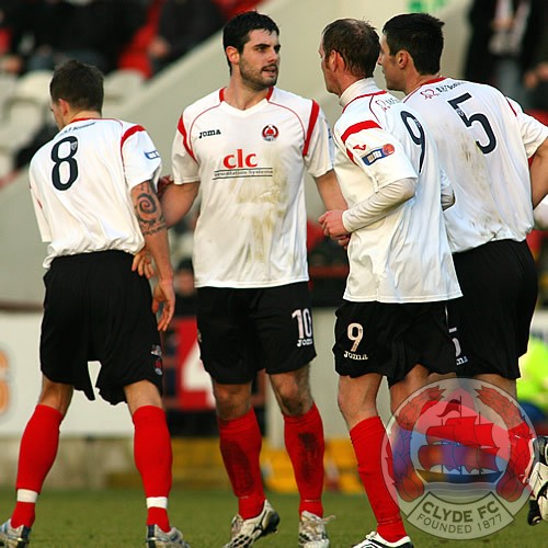 Marc McCusker is congratulated for scoring.